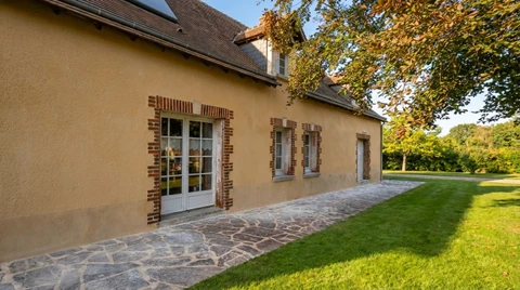 Façade latérale d'une maison de campagne française, style normand